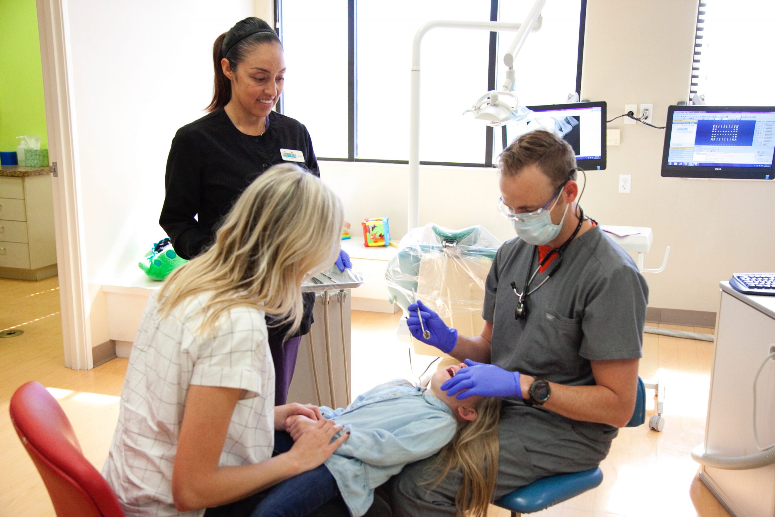 Dr. Taylor caring for a young patient at Kids Grins